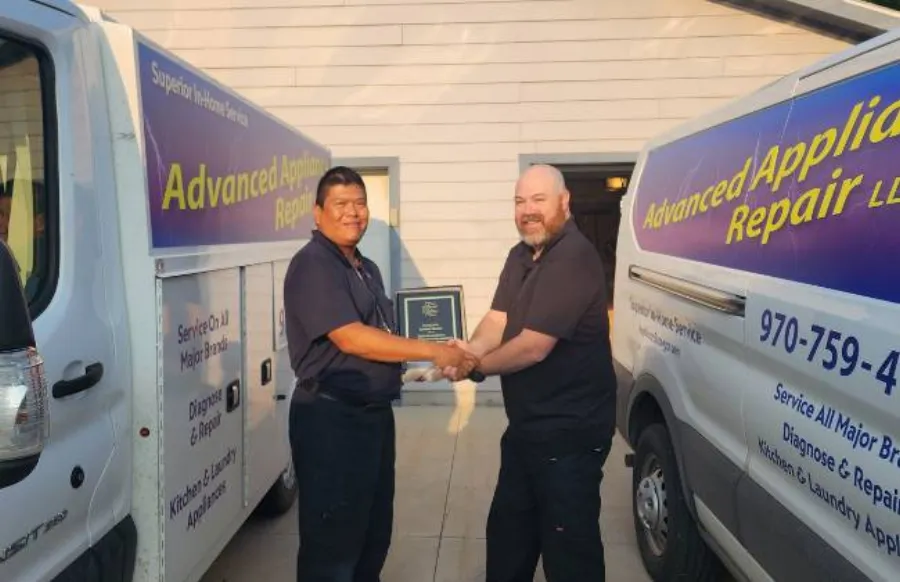 Advanced Appliance Repair technicians with a service van in Durango